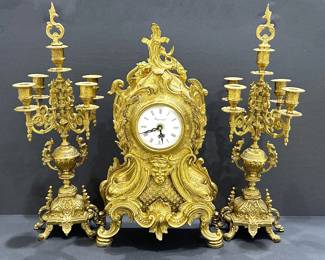 Ornate Gilded Brass French Louis XIV Style Mantel Clock Garniture set, by Imperial.  Made in Italy.   It currently has a battery powered clockworks.  