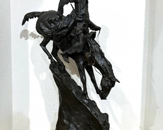 Large Remington Bronze, Mountain Man, depicting a frontiersman on a horse.   It is a reproduction.   It is 27 inches in height not including the marble base.  