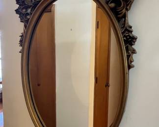 Oval ornate gold mirror