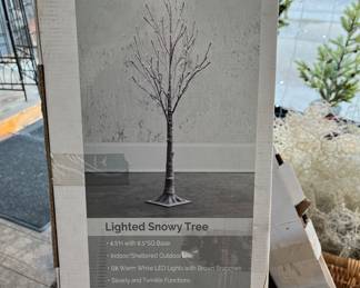 Two lighted snowy Christmas trees