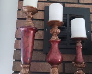 Trio of candlesticks with candles