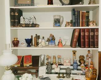Antique books, figurines, oil lamp