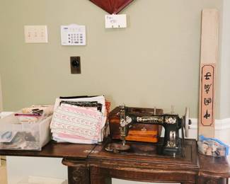 Antique treadle sewing machine, sewing notions and fabric, large Oriental fan