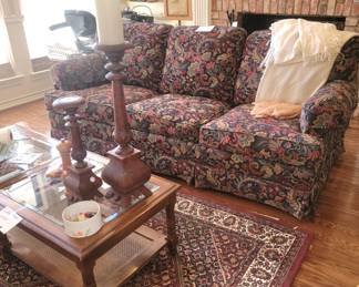 Sleeper sofa, area rug, wood candle holders, coffee table