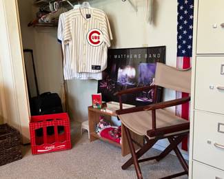 In the office. Chicago cubs items, file cabinets, folders, printer paper, suitcases, etc