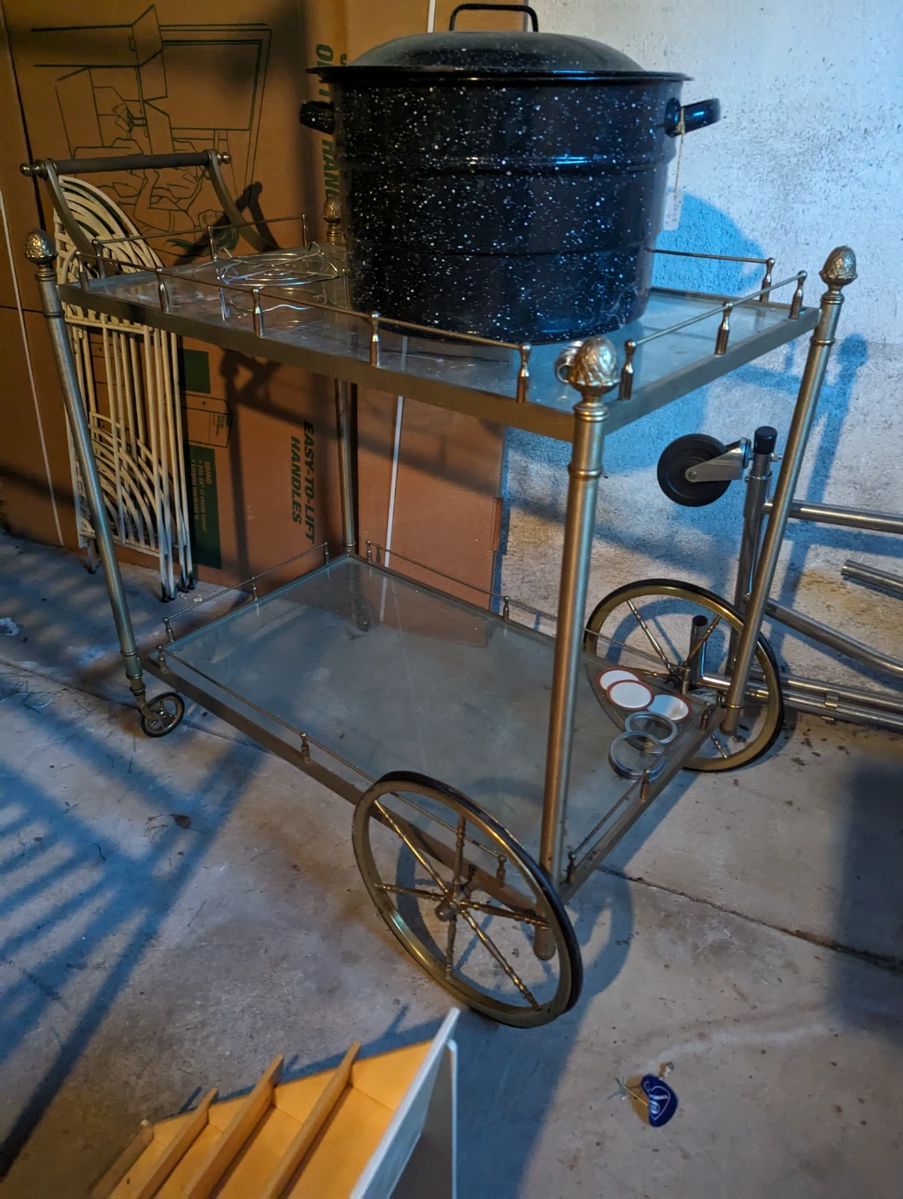 Vintage gold or brass bar cart with glass shelves