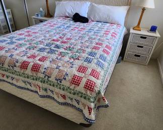 Looks like a Full Size Bed with Wicker Headboard...  I'll verify the size when pricing the house.  