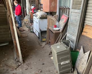 various items on back porch area of house, at basement staircase