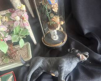 antique dog figurines, antique old paris style vase in victorian dome with flowers, yards and yards of various colors of fabric and clothing