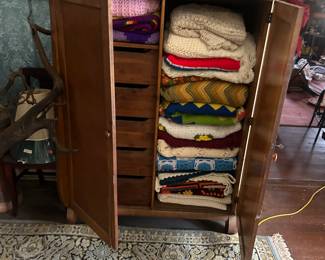 linen pressed filled with items, quilts etc