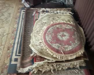 stack of rugs in one of four bedrooms