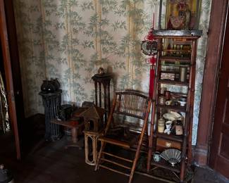bamboo chair, what not stand and items on bedroom wall