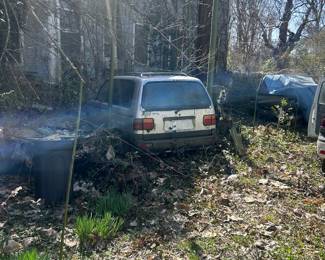 old Mazda van in side yard of house