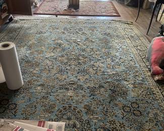 dozens of rugs of various sizes , styles and colors