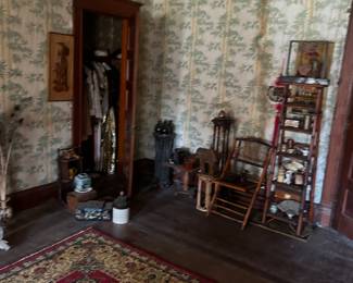 corner view of bedroom with vintage clothing and quilts in closet