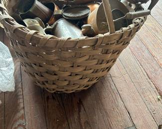 antique basket with handle full of copper items