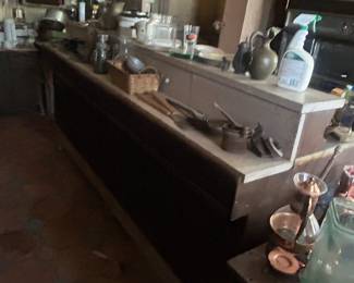 old store cabinet with items in center of kitchen floor