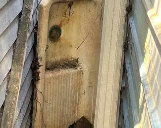 old vintage sink between out buildings at house