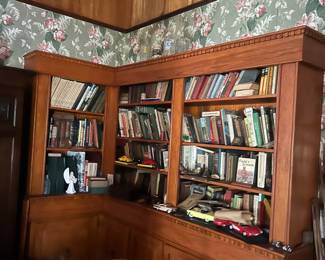 library of home with custom built bookcases full of vintage and antique books