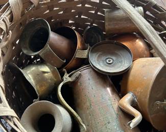 antique handmade basket full of vintage and antique copper items