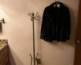 Brass coat rack and mink jacket