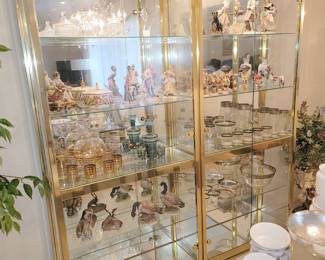Brass and glass lighted curio cabinets