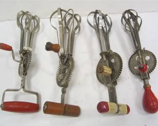 FOUR ANTIQUE EGG BEATERS WITH WOOD HANDLES