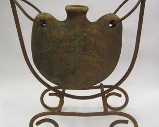 YARD ART HANGING WEATHERED POTTERY FLASK ON WROUGHT TALL STAND