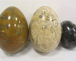 THREE STONE EGGS. ONE WITH FOSSIL