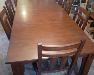 Oak finish Dining Room Table with 8 Matching Chairs.
This table fully extended is 106" (8' 10") long.
42" wide and 30' high. Without table extensions, the table top is 70" (5' 10") long.
Each of the 2 extensions is 18".
Comes with two master chairs with arm rests and 6 side table chairs. Chairs overall are 40" tall in back, 21" wide and 23" deep.