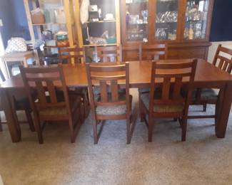 Oak finish Dining Room Table with 8 Matching Chairs.
This table fully extended is 106" (8' 10") long.
42" wide and 30' high. Without table extensions, the table top is 70" (5' 10") long.
Each of the 2 extensions is 18".
Comes with two master chairs with arm rests and 6 side table chairs. Chairs overall are 40" tall in back, 21" wide and 23" deep.
