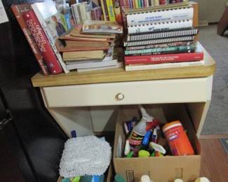 assorted cookbooks and cleaning supplies