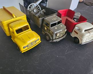 From Left to Right                                                                                     1950's Buddy L Coca-Cola Delivery Truck                                         
1950's Marx Lumar Army Pressed Steel Truck                            
 Structo Cargo