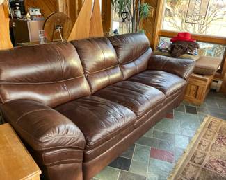  . . . another brown leather couch