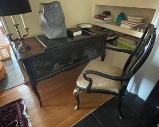 . . . a black shellacked desk with matching chair