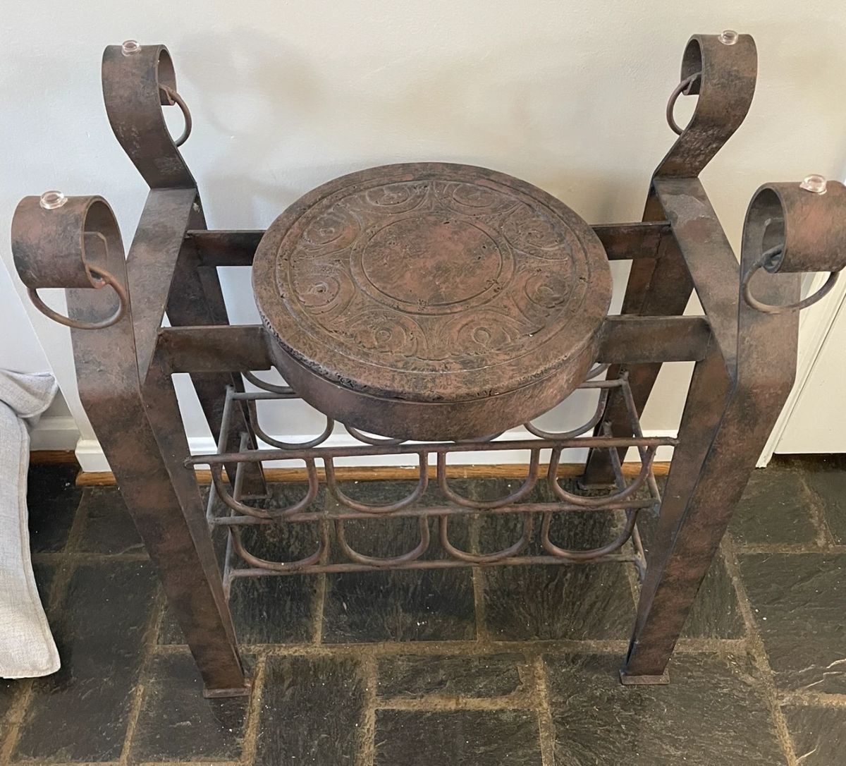 Unique metal seat with wine rack.