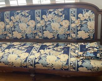 Extra long antique sofa with wood frame and upholstered seat. 