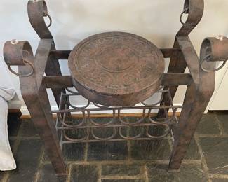 Unique metal seat with wine rack.