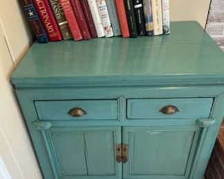 Small painted cabinet and books.