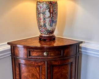 Rose medallion lamp on a Theodore Alexander corner cabinet 