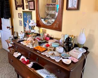 Vintage dresser filled with small clothing items.
