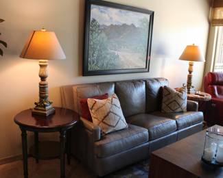 Gray leather sofa is quite contemporary, like new and for sale!