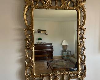 Vintage carved wood mirror with plaster and gold paint. French 18th century style, made in mid 20th century. 