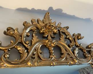 Close up of the carving on the vintage mirror.