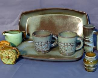 Frankoma Pottery 14" Serving Bowl, 11.5" Serving Tray, Coffee Mugs, Creamer, Toothpick Holders, Metal Trivet, Painted Terra Cotta Coin Bank, And Vases, Total Qty 15