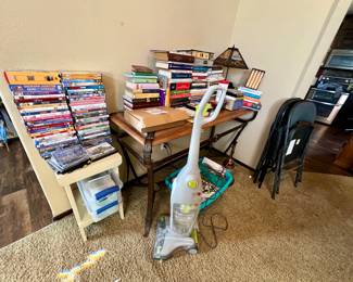 DVDs, Books, vacuum, entry table, and small table