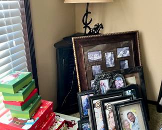Christmas boxes, wall decor, lamp, and corner table