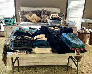 Women's clothing and queen bed