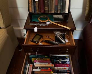 books, small cabinet, magnifying glass