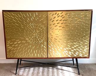 RUVE205 Ashley Furniture Signature Design Accent Cabinet  Media chest is made of solid and engineered wood with brass-tone metal door fronts. Built with 2 shelves behind cabinet doors with touch latch closure.
